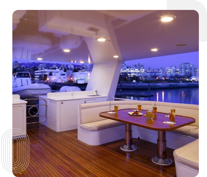 Luxury yacht deck at night, city view.