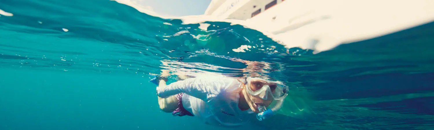 A person in the water wearing a mask and goggles