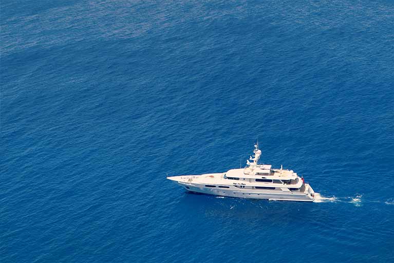 A white boat floating on top of the ocean.