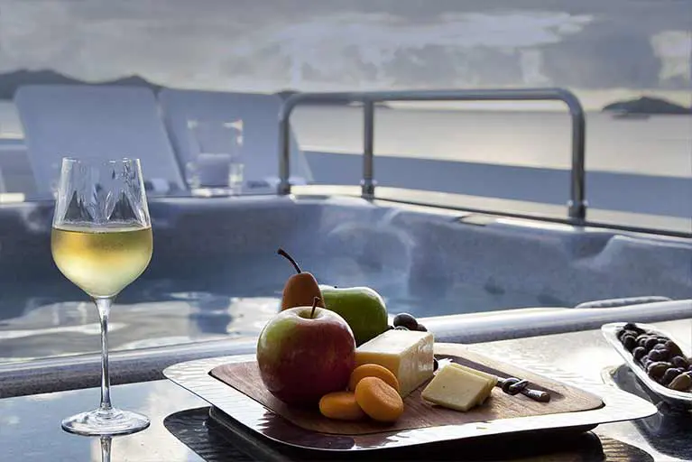 A plate of fruit and cheese on the table